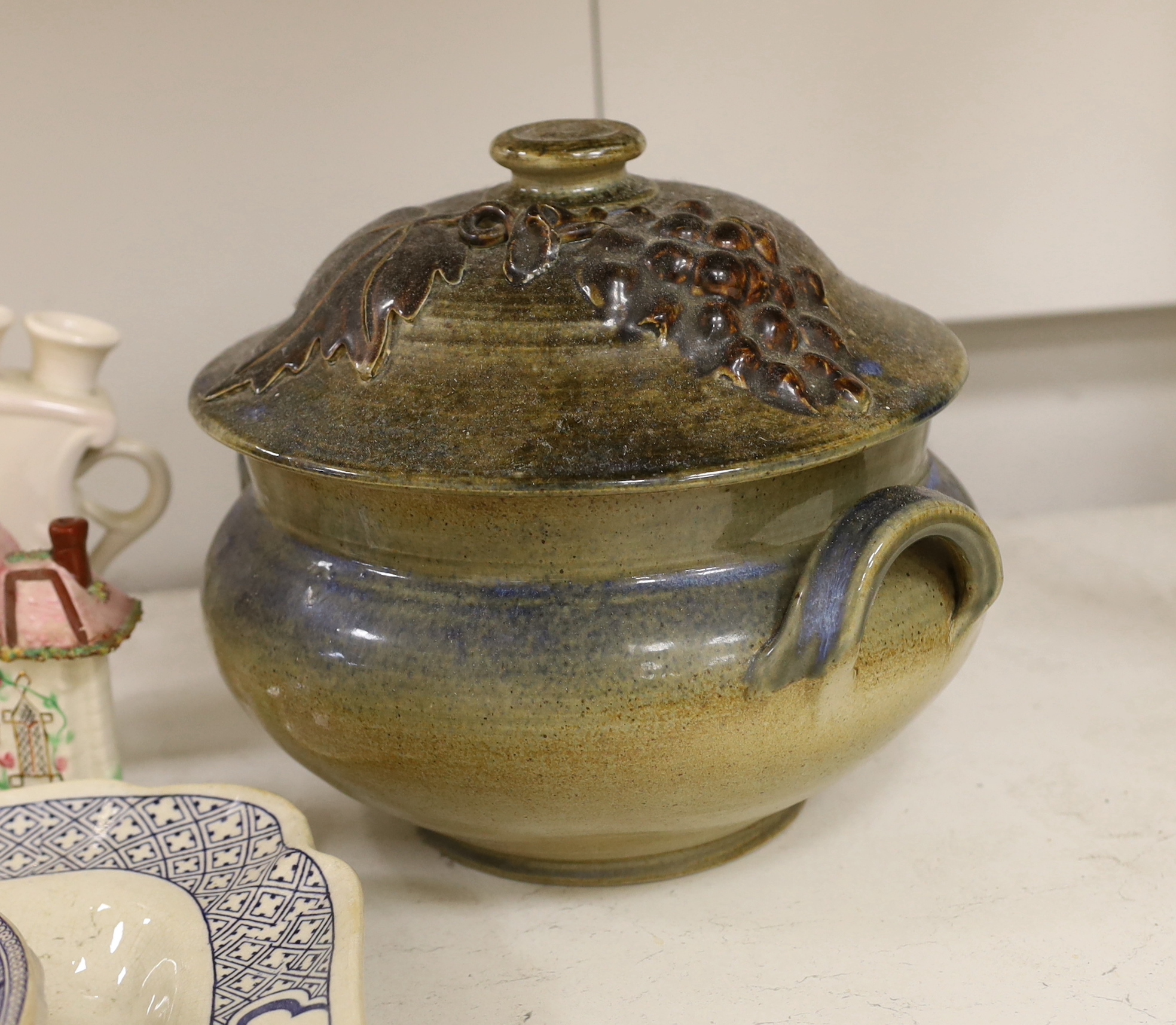 A large pottery tureen and cover, a large centrepiece and mixed ceramics including meat platters